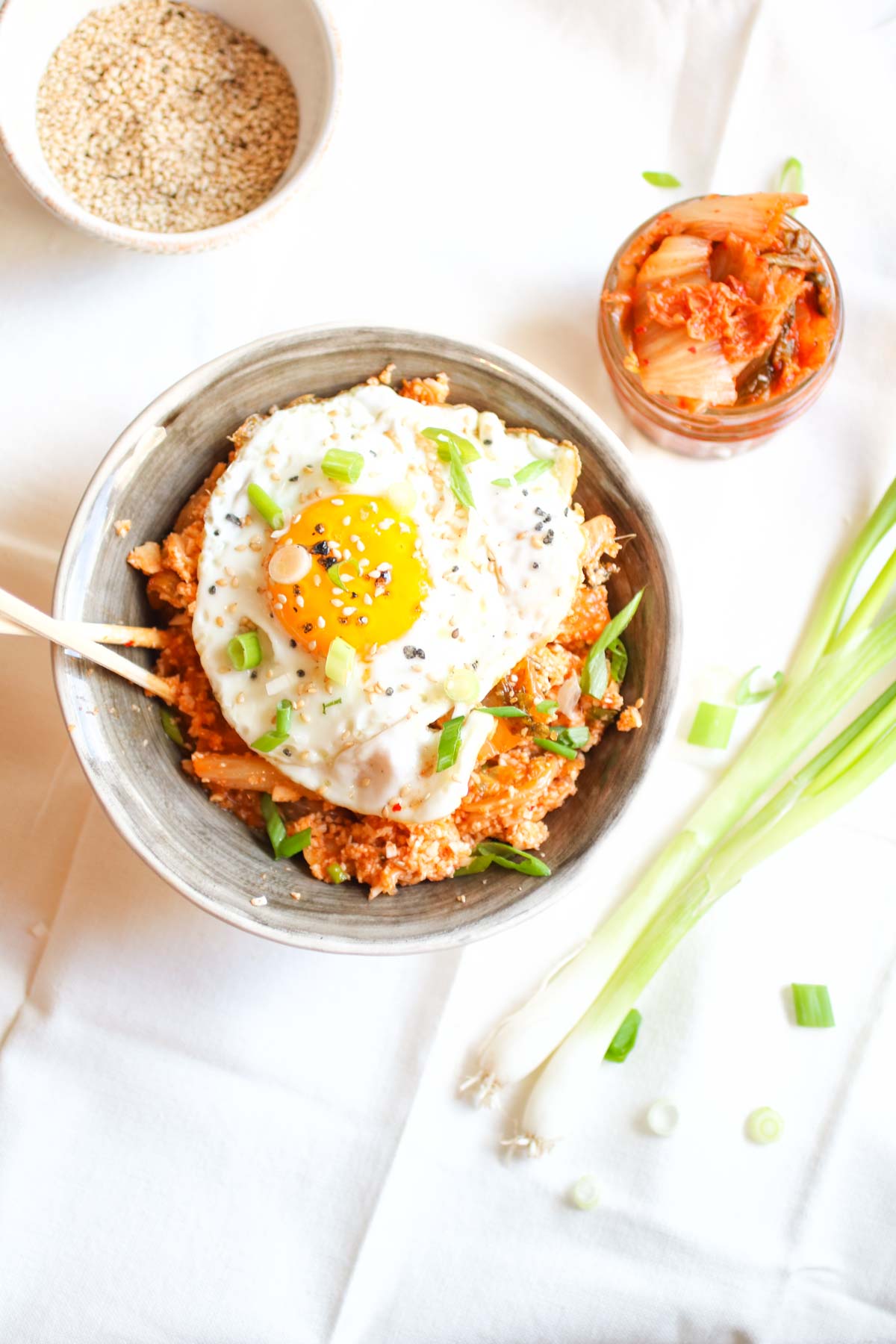 Spicy Kimchi Cauliflower Fried Rice with a Perfect Egg on Top. Grain free, gluten free, paleo, whole30, crazy delicious and done in 15 minutes! abraskitchen.com