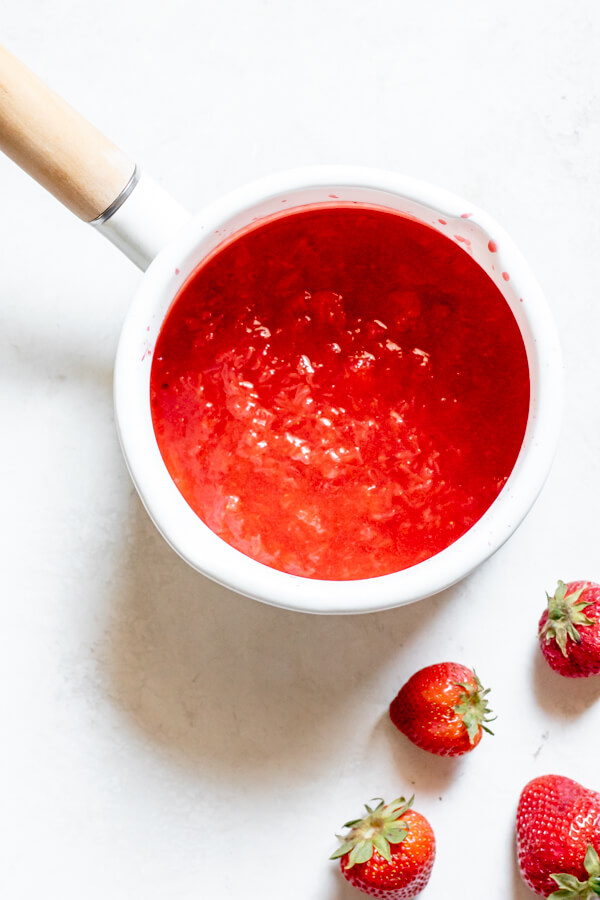 homemade fresh strawberry sauce in a small white pot