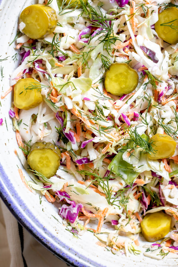 Close up of Dill Pickle Coleslaw in a blue pottery bowl