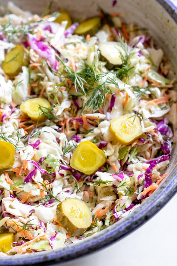 Close up of Dill Pickle Coleslaw in a blue pottery bowl