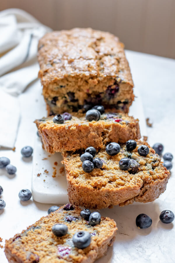 Blueberry Banana Bread made with Oat Flour on a white background, thick slices