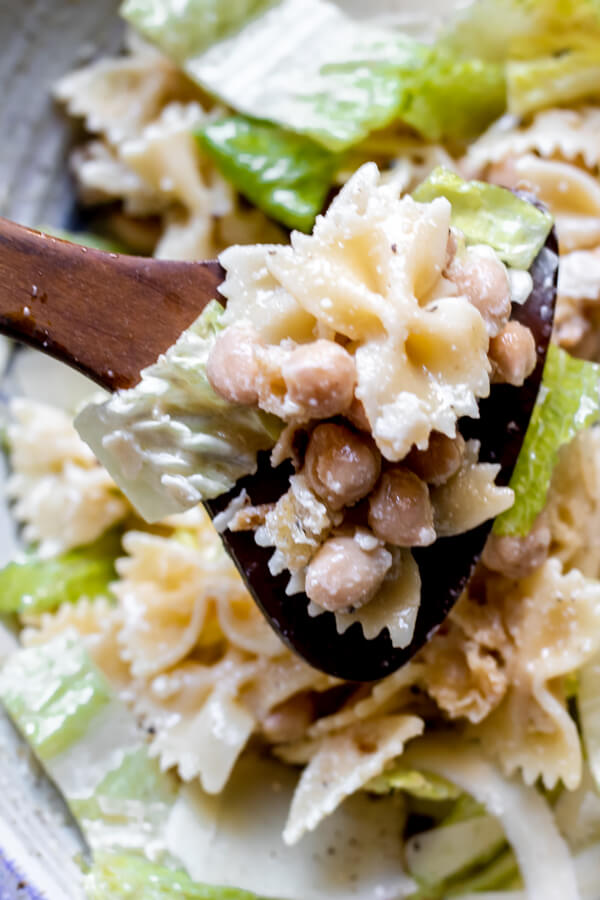 wooden spoon filled with Chickpea Caesar Pasta Salad