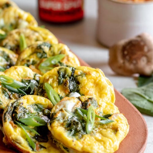 close up of egg muffins on tray with kimchi in background