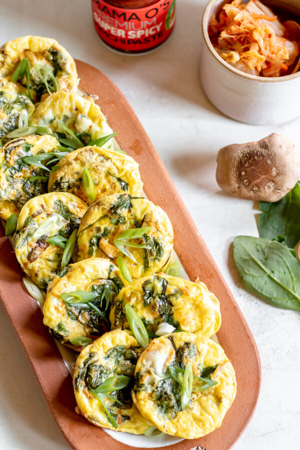 large tray with egg muffins with kimchi and spinach