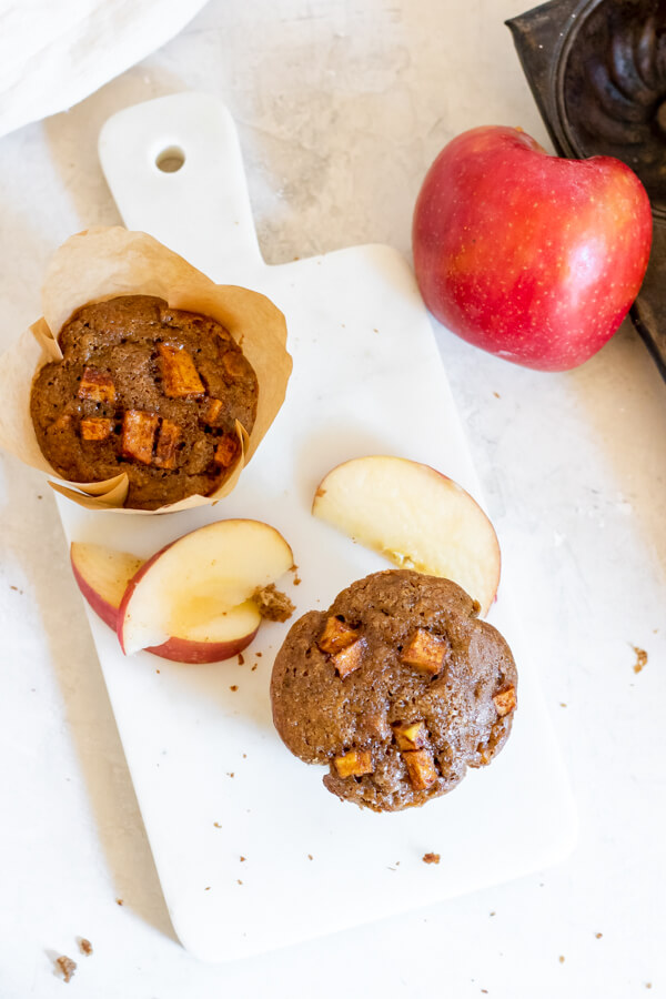 2 apple spice muffins on white background