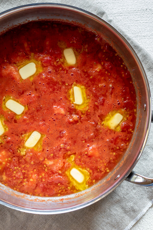 butter simmering in tomato sauce in a large pan