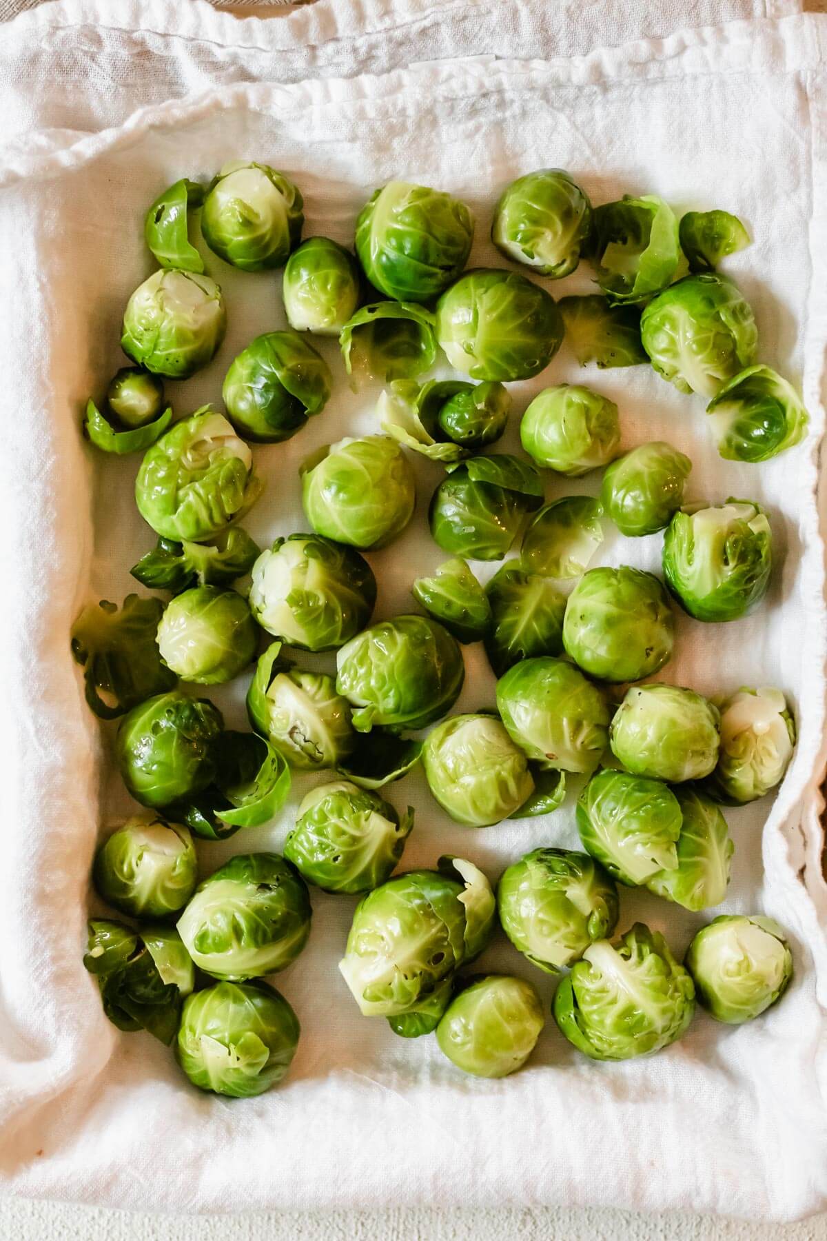 drying brussels sprouts on a clean kitchen towel