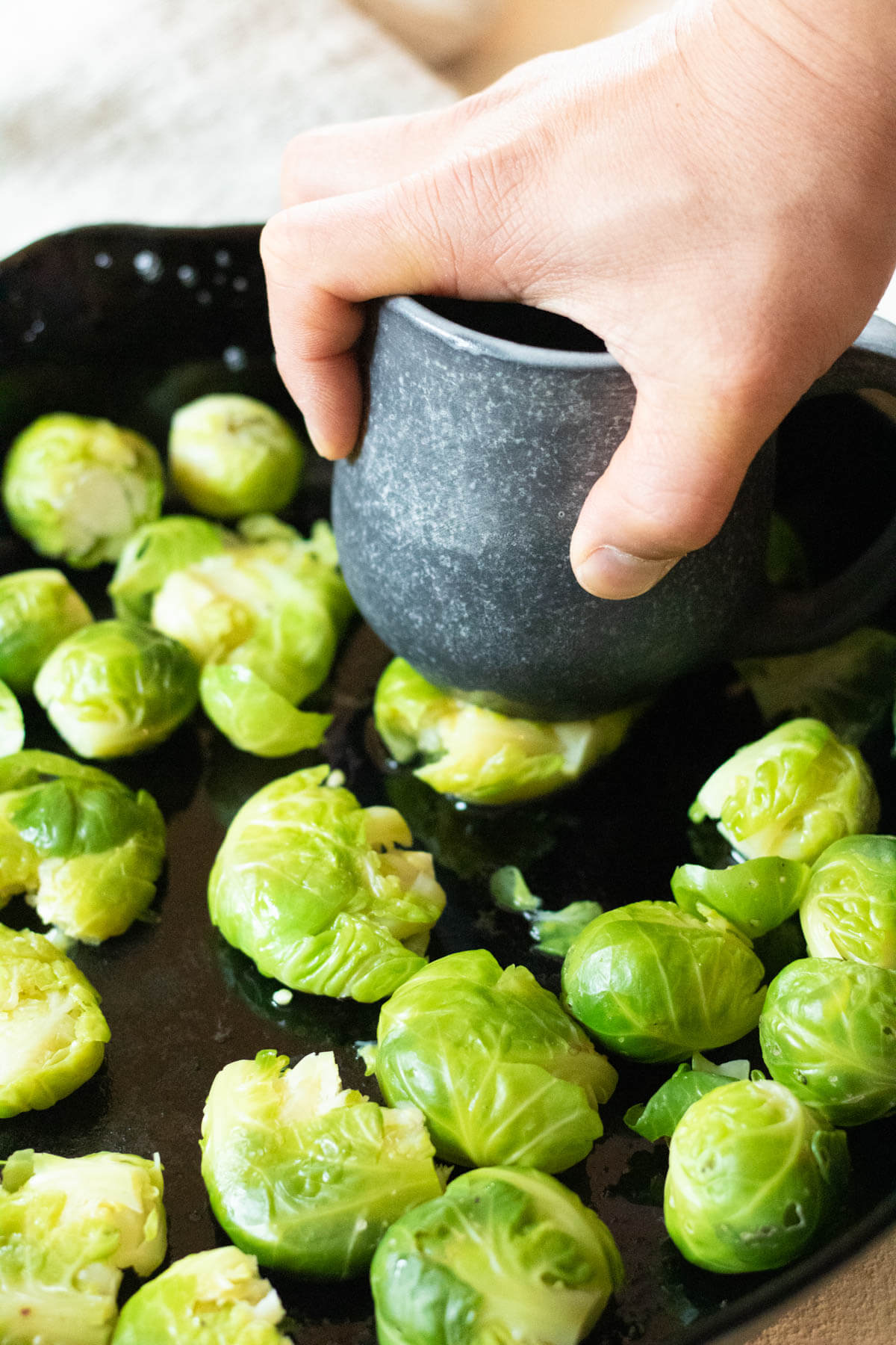smashing a brussels sprout with a heavy ceramic mug