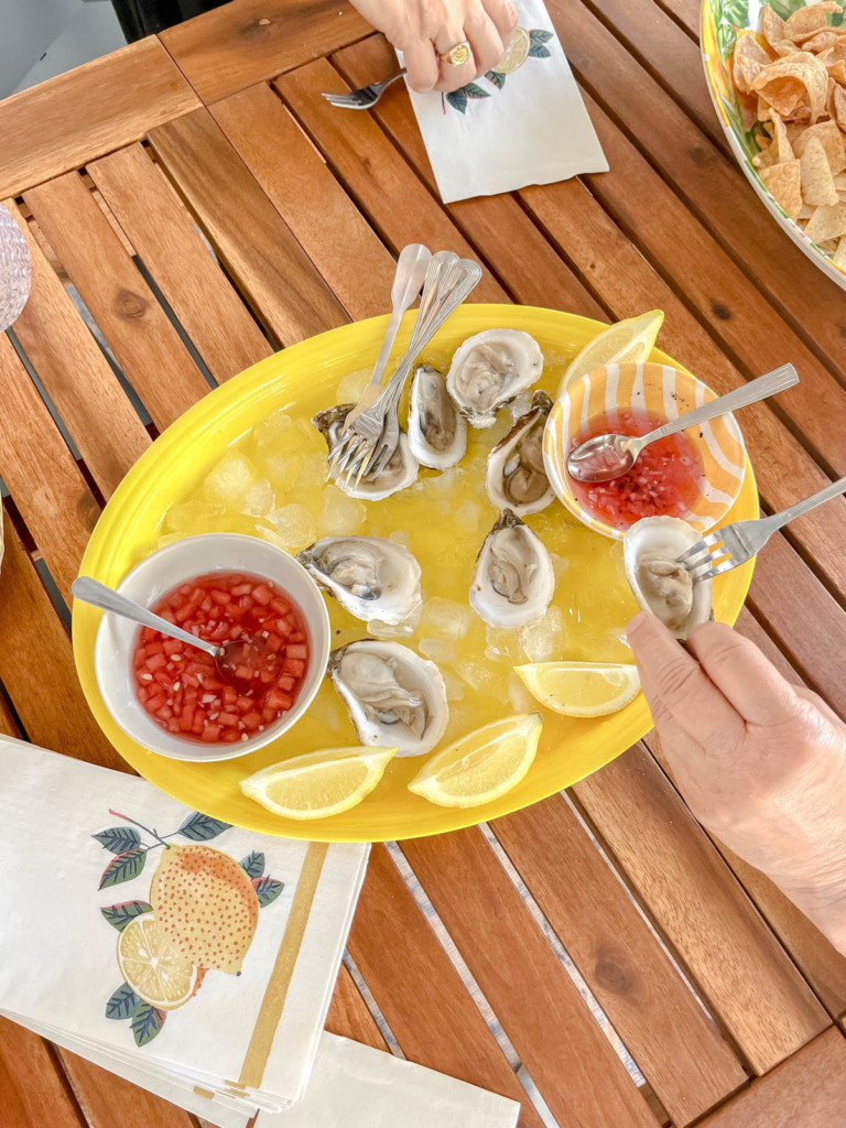 large tray of oysters on wood table