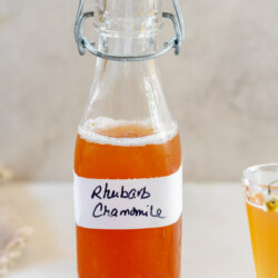 Rhubarb Chamomile Simple Syrup in a bottle on a white background