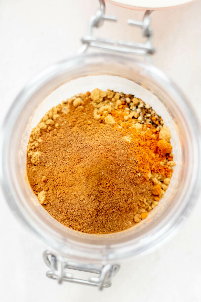 moroccan spice blend in a jar on a white background