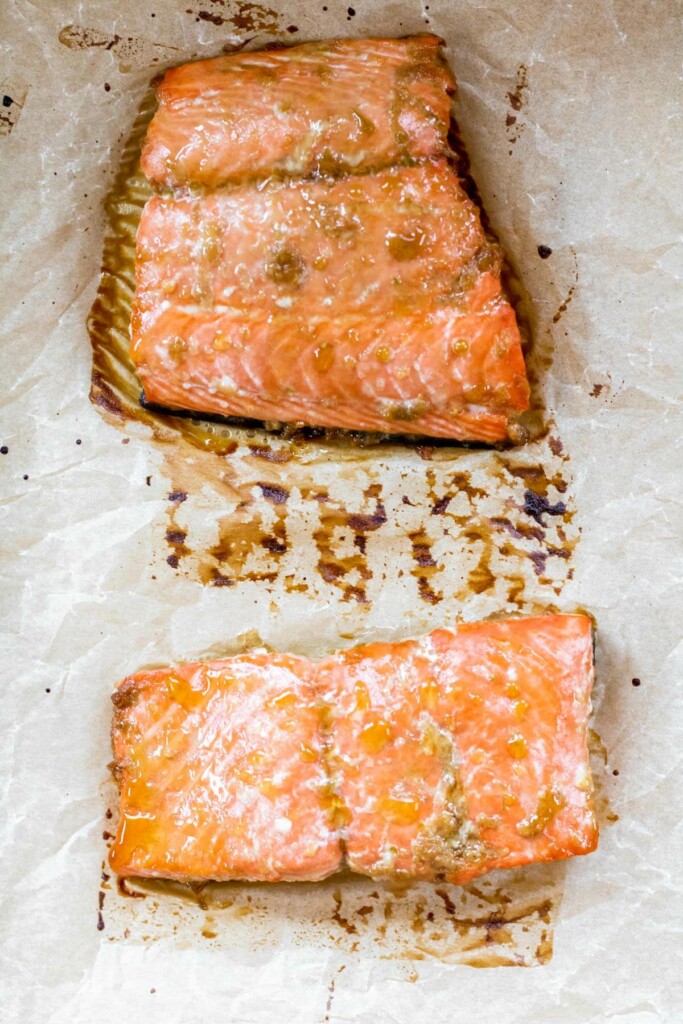 2 pieces of cooked wild salmon on parchment paper