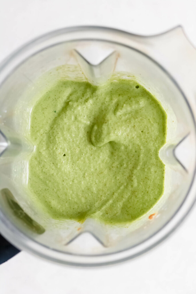 Close up shot of green smoothie in blender