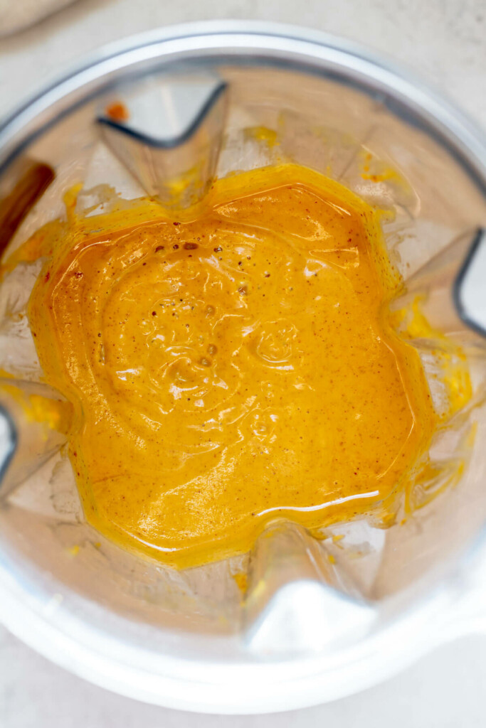 blender close up photograph of wet ingredients for pumpkin bread