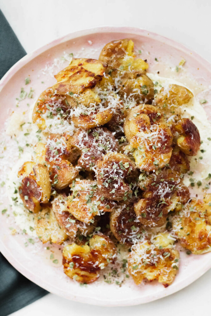 pink plate piled high with crispy truffle parmesan potatoes