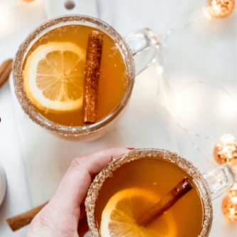 image of hand holding hot toddy for pinterest