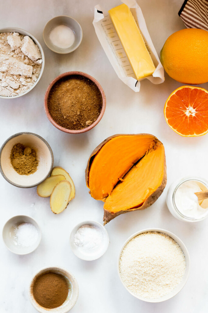 A selection of ingredients on a white background for sweet potato cake
