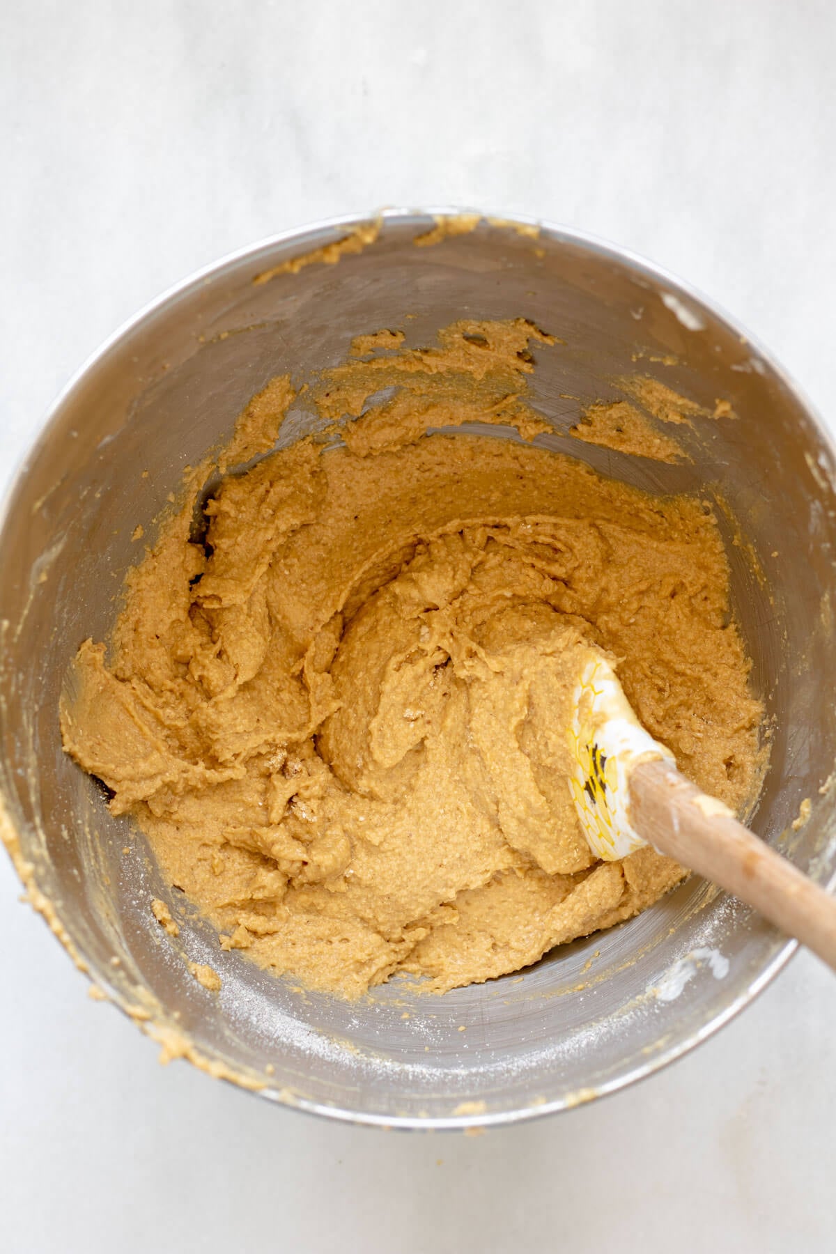wet ingredients and dry ingredients combined in a mixing bowl for blueberry muffins