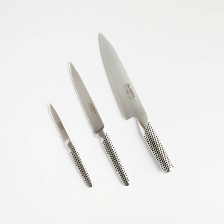 This set of three essential knives is crafted in Japan using a manufacturing method that dates back to the Samurai sword. The knives have a distinctive modern design with seamless, hygienic one-piece, stainless-steel construction, professional performance and a dramatic signature dimple pattern on the handles. Slip-resistant, ergonomic hollow handles are filled with sand for ideal weight and balance. This set includes a 7-inch chef's knife, 4-inch utility knife and 3-inch paring knife for slicing, dicing, peeling and chopping with ease.