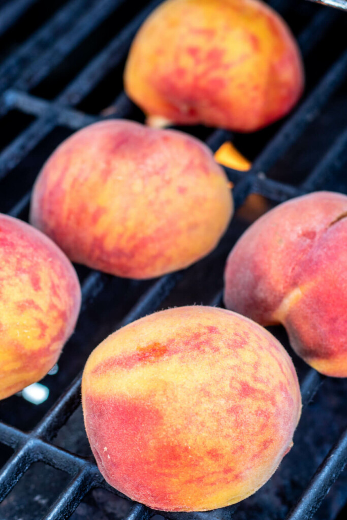 peaches cut in half on grill