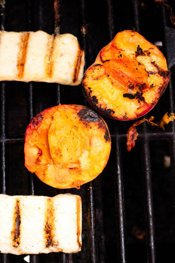 1 peach and 2 pieces of halloumi cheese on a grill