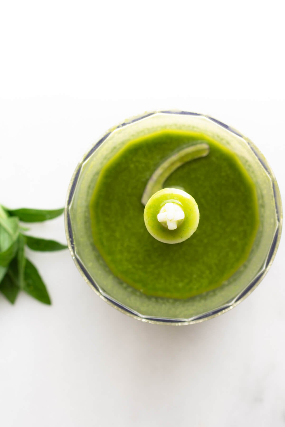 green basil vinaigrette on white background