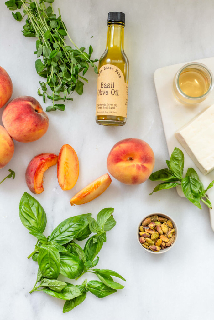 peaches, basil, and halloumi cheese on a white background
