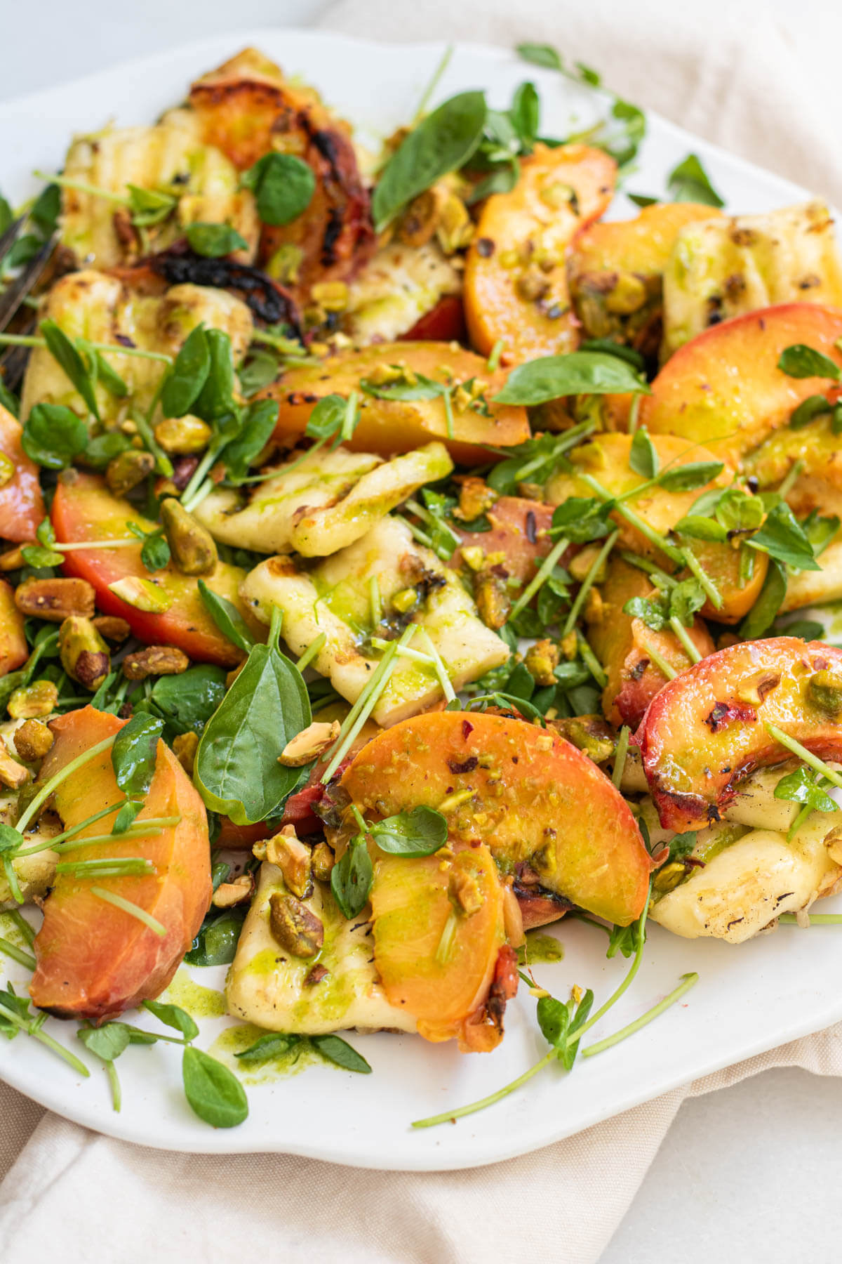 up close shot of peaches, basil, and microgreens
