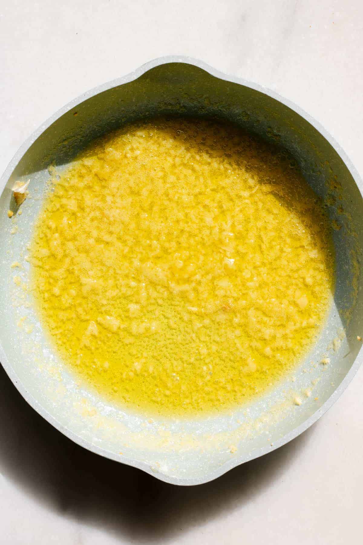 small saute pan wtih garlic butter sauce