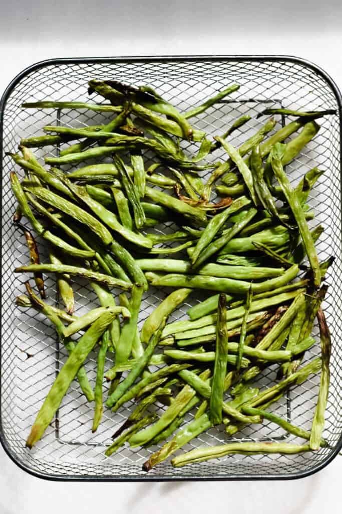 air fryer basket with green beans
