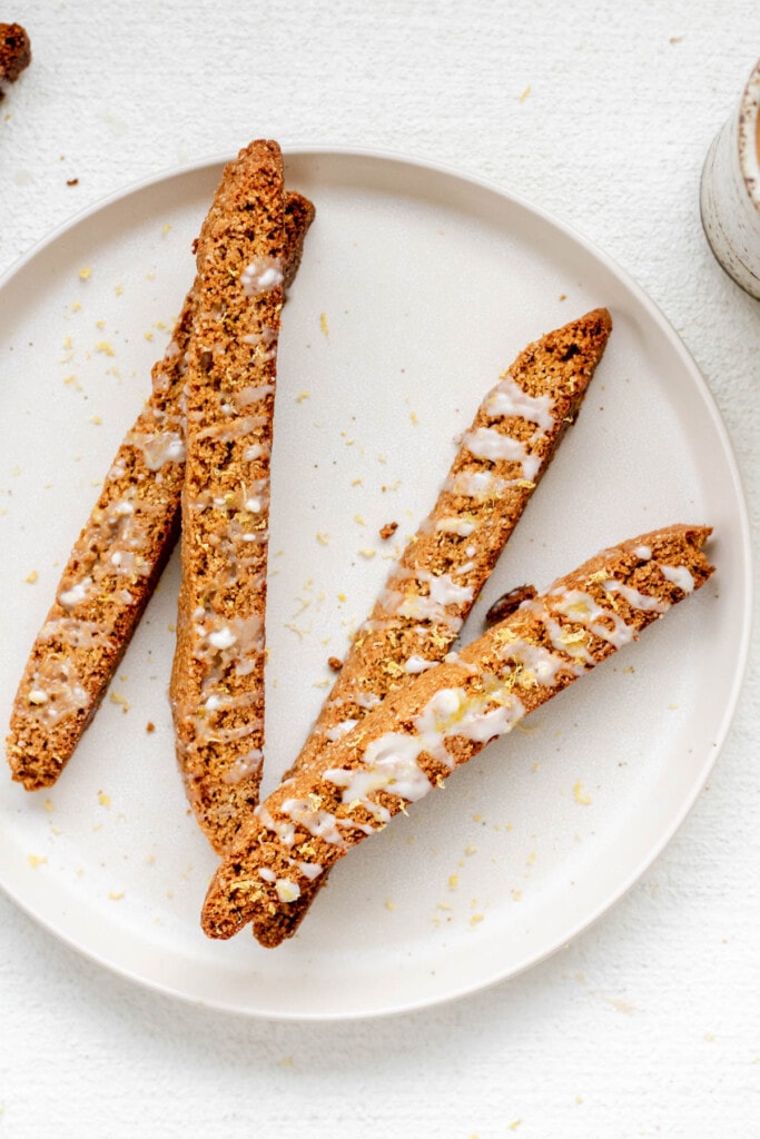 a white plate of almond flour biscotti on a white background