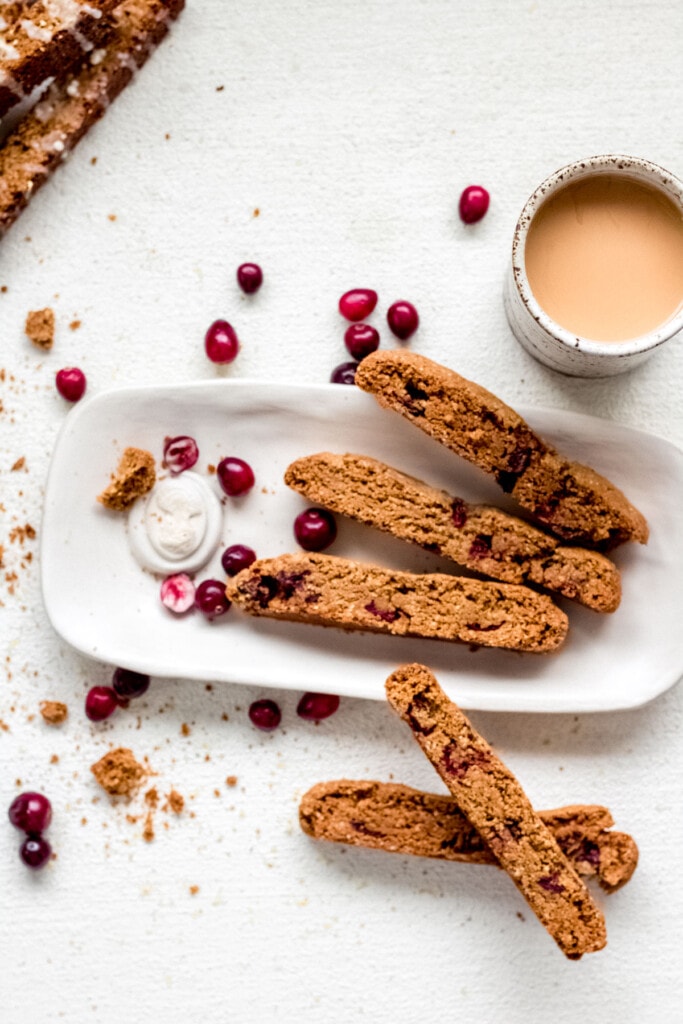 a white plate of almond flour biscotti on a white background