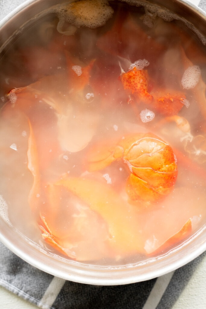 A large pot with lobster boiling away to make a lobster stock