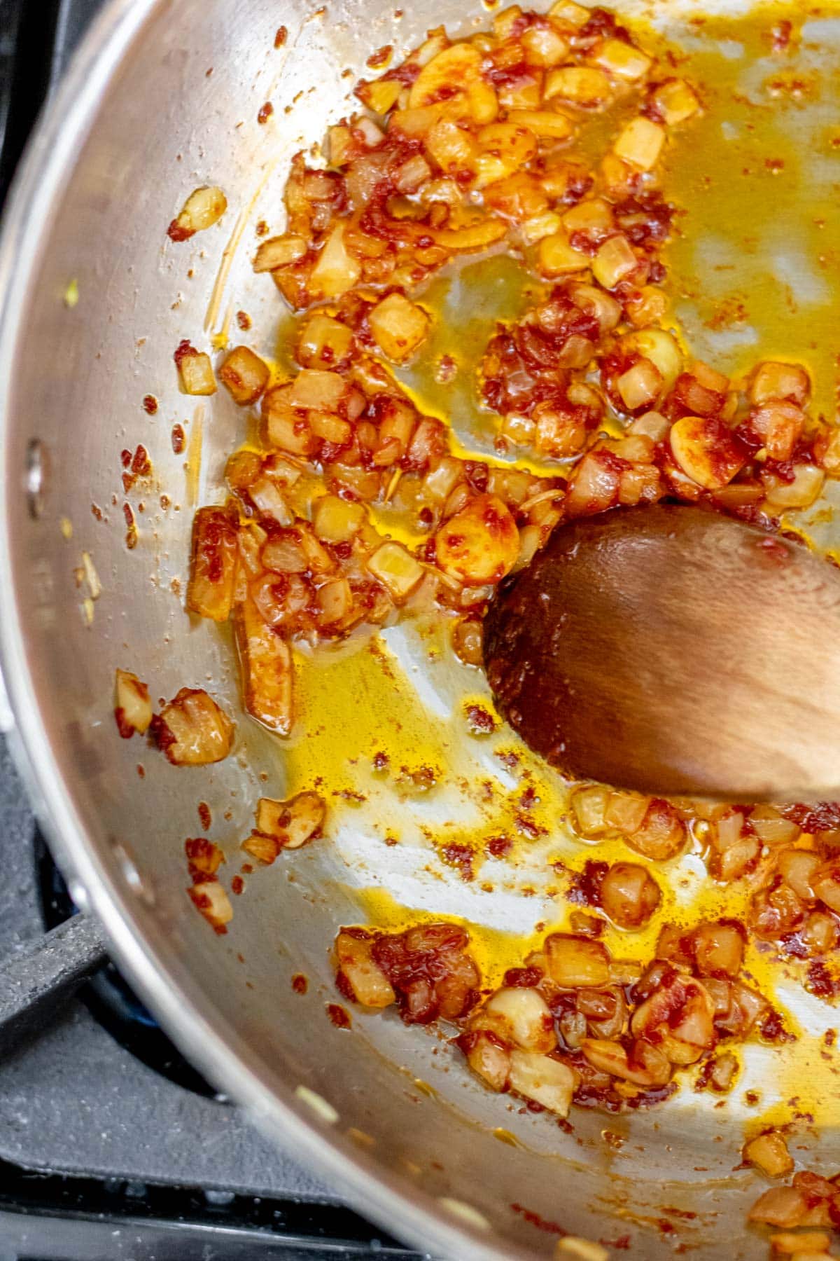 A pan of onions sauteed with tomato paste step 2 of making lobster pasta