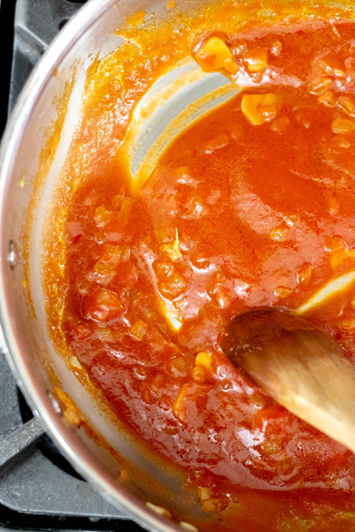 A pan of onions and tomato sauce