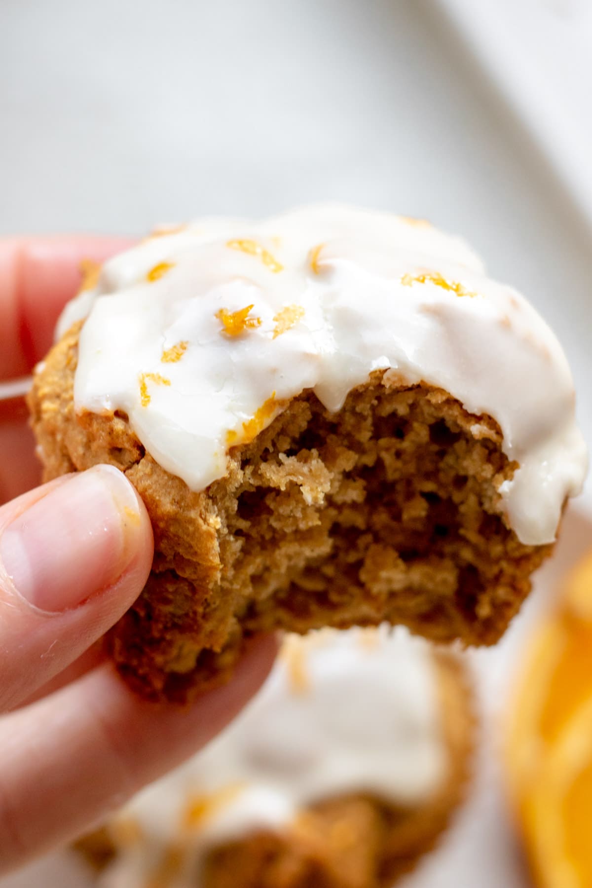 hand holding a gluten free orange muffin