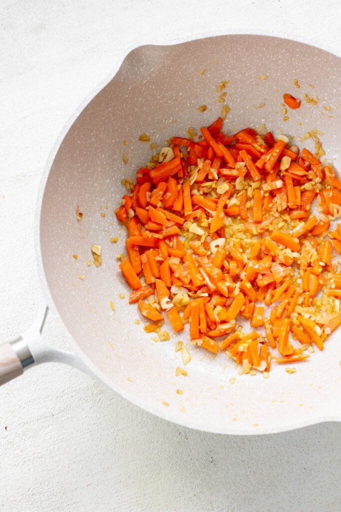 pan of sauteed carrots, onion, garlic, and ginger