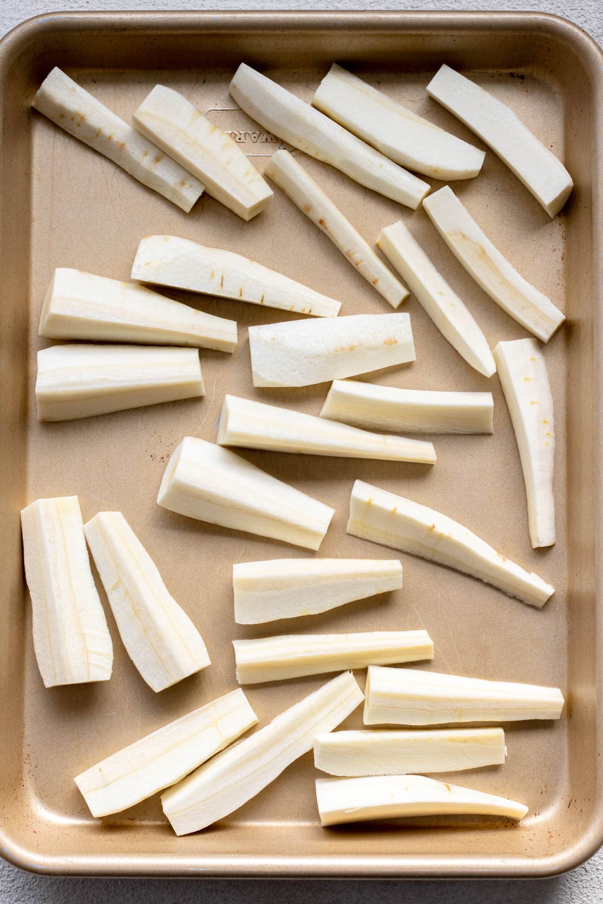 A sheet tray with roasted parsnips