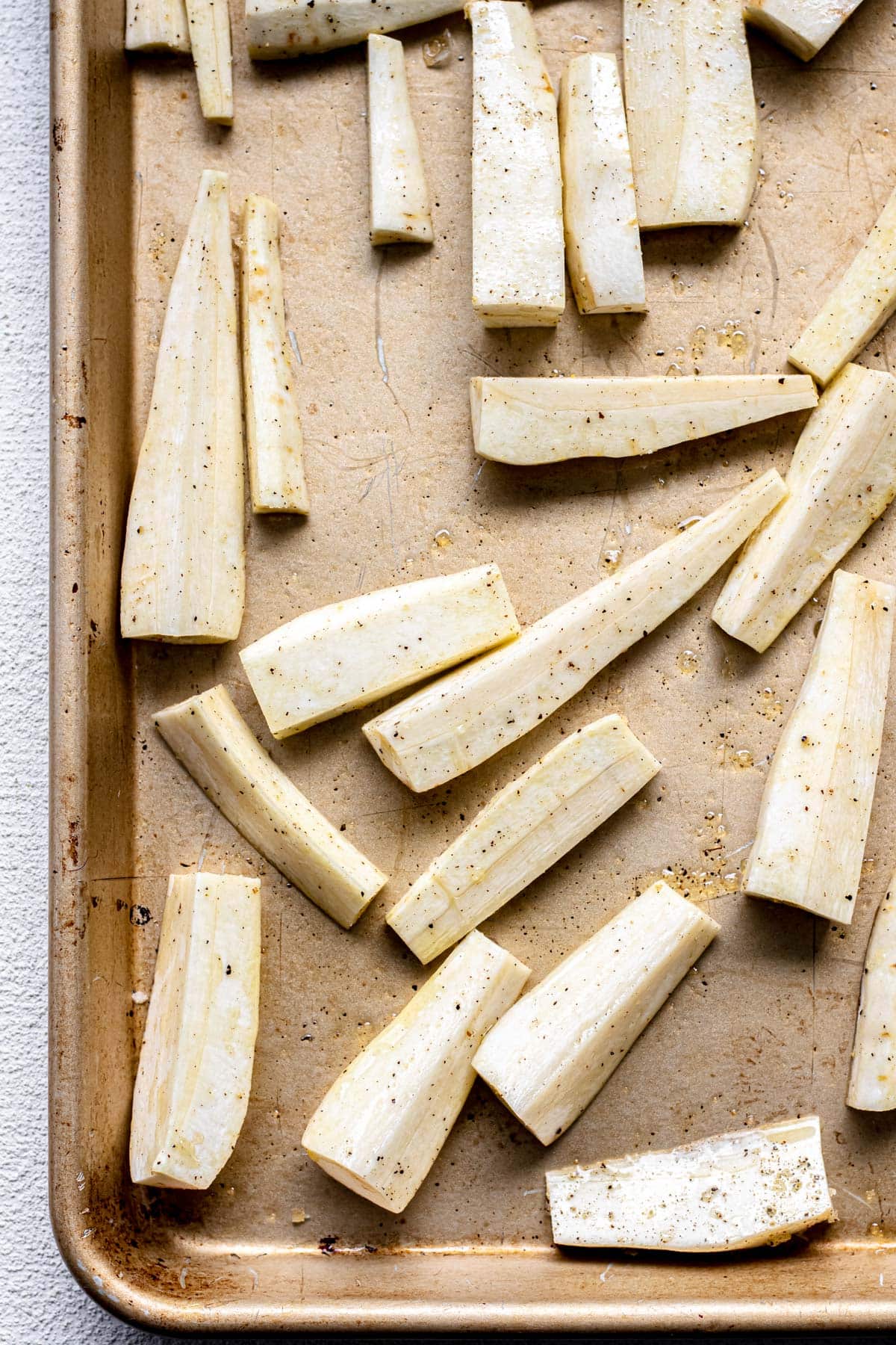 A sheet tray with roasted parsnips