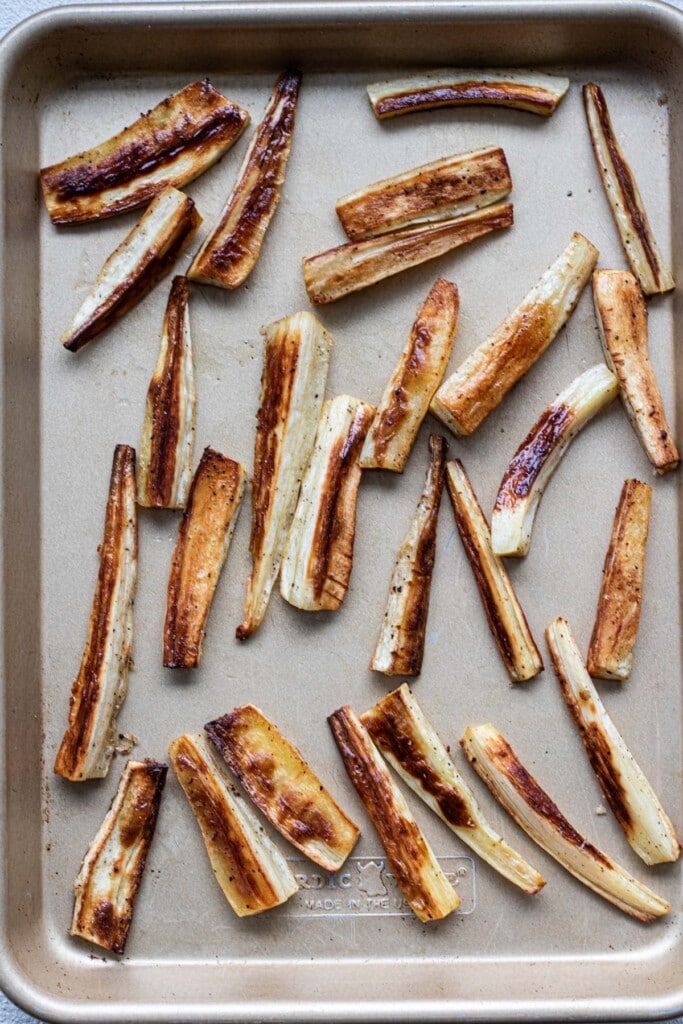 A sheet tray with roasted parsnips