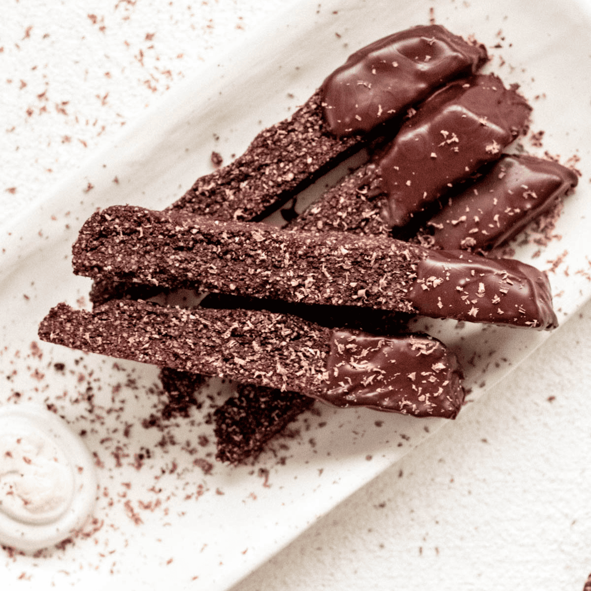 A small rectangular platter filled with coffee cardamom biscotti dipped in dark chocolate