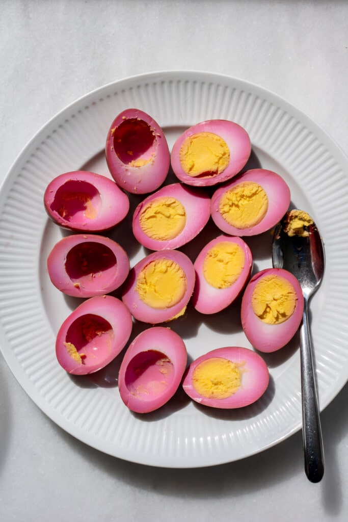a plate of pickled eggs sliced in half