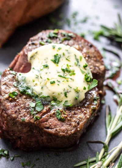 filet mignon on a plate with herb butter