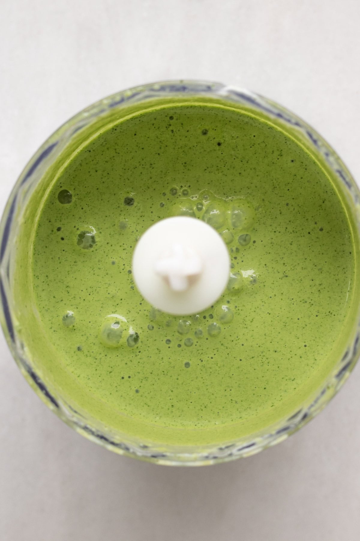 a food processor with cilantro jalapeno sauce