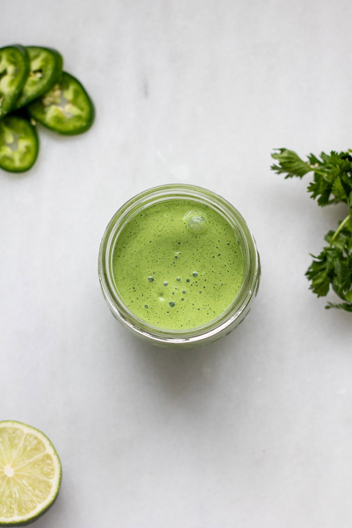 a jar of green cilantro jalapeno sauce