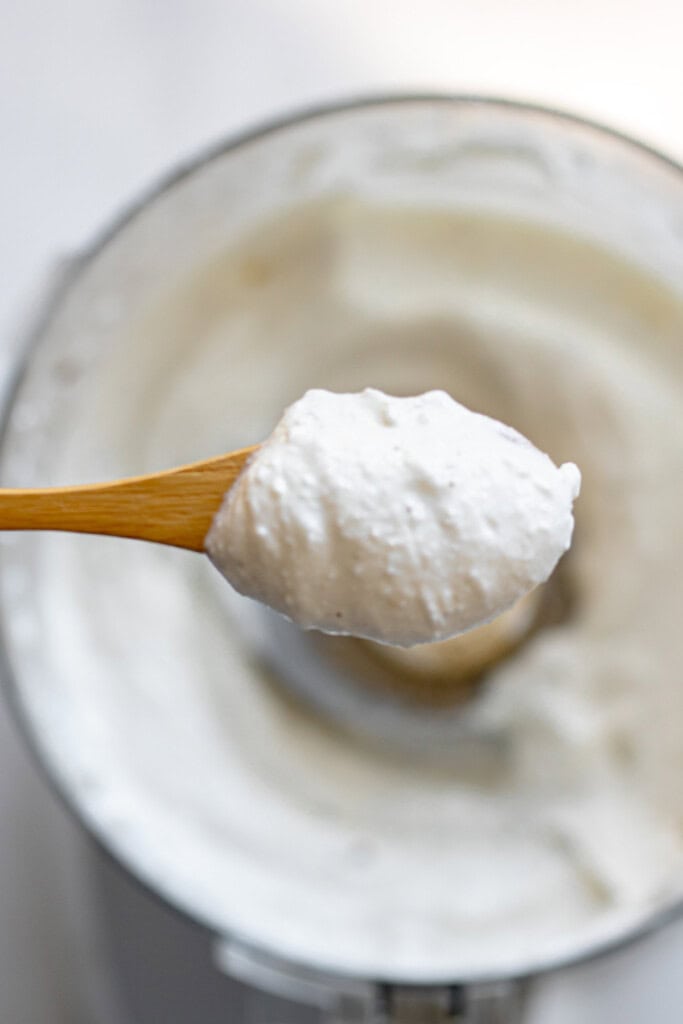 spoon holding whipped feta and cottage cheese