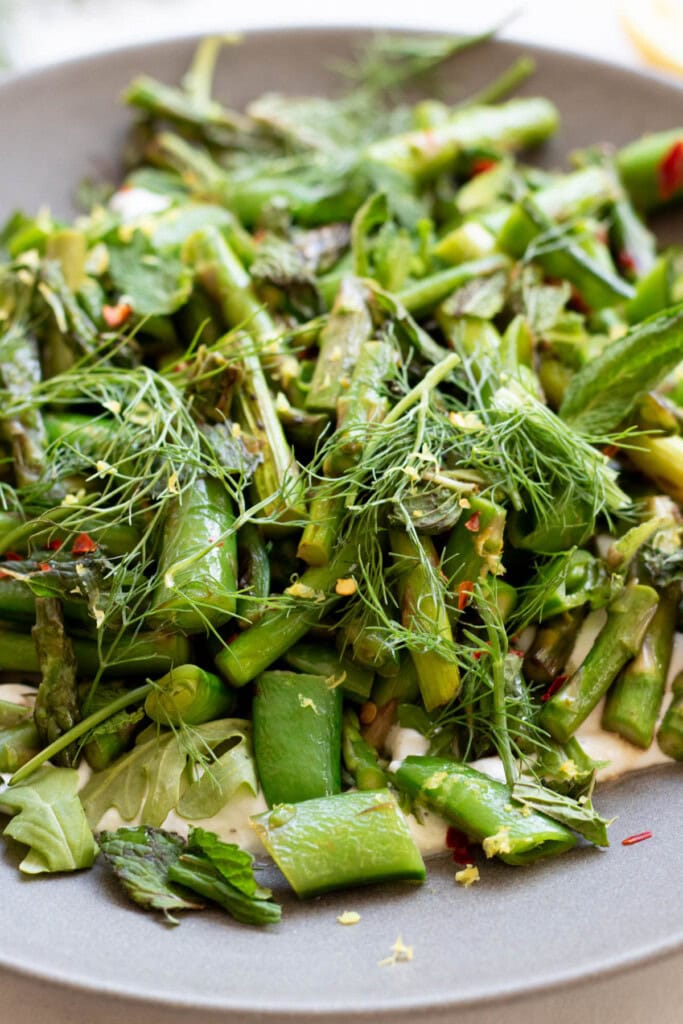 close up of sugar snap pea salad with asparagus and herbs