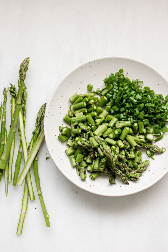 chopped asparagus and scallions on a plate