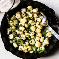scallops and herbs cooked in a pan