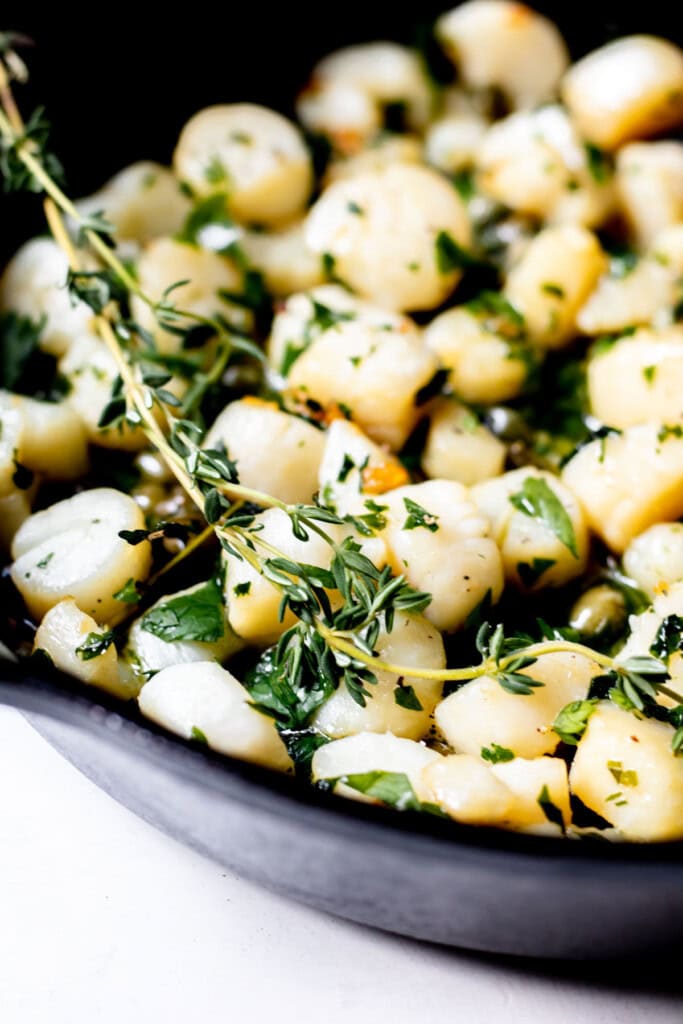 scallops and herbs cooked in a pan